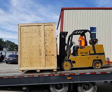 forklift loading crate on flatbed